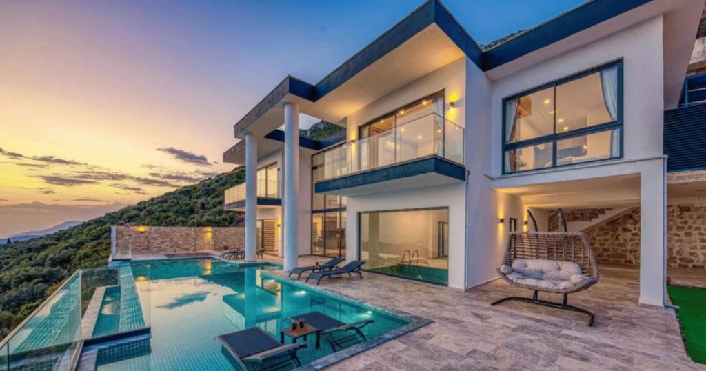 Luxury off-market waterfront villa in Miami at sunset, featuring an infinity pool and modern architecture. A prime example of high-end real estate available only through private networks